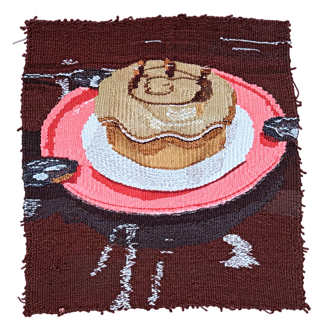 Plain-weave tapestry of a cake on a pink plate, woven in hand-dyed wool at Penland School of Craft.